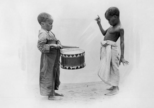 Young African boys with a military drum