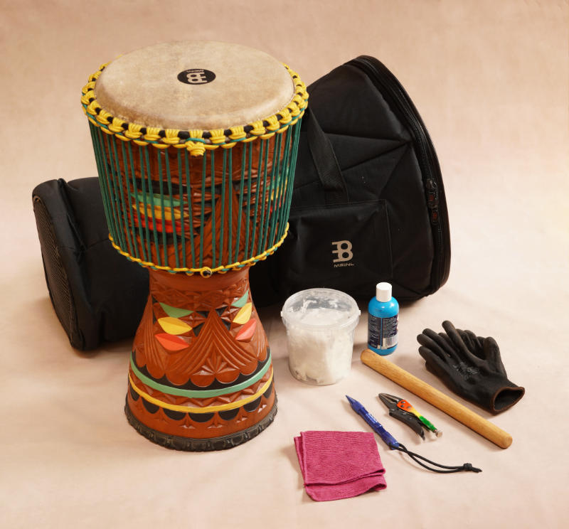 Complete djembe care kit with drum, cleaning cloths, shea butter, protective case and maintenance tools