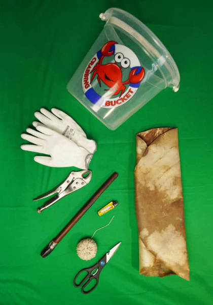 Djembe repair tools - a bucket, stick, gloves, pliers, skin, string, lighter