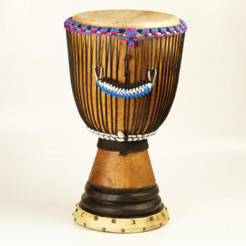 A djembe with birhgtly coloured rope in purple, blue and white. 